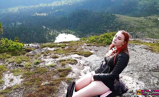Red head plays with herself outdoors on mountaintop